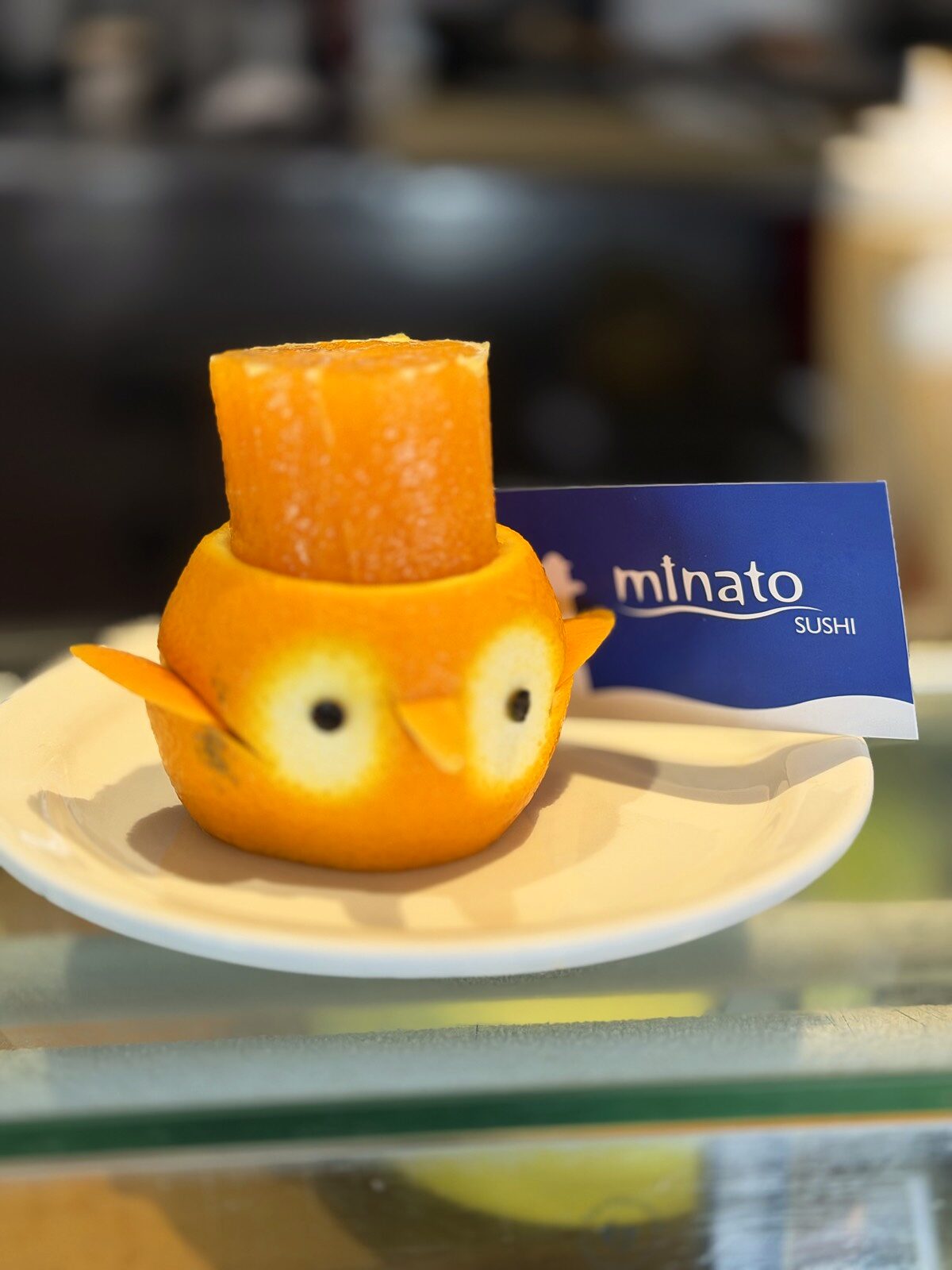 Hand-carved orange bird at Minato Sushi
